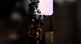 Desi babe takes a shower and shows off her sexy body in this outdoor video 1 min 20 sec