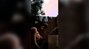 Desi babe takes a shower and shows off her sexy body in this outdoor video 1 min 50 sec