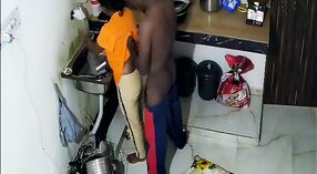Indian aunt in yellow sari gets naughty with her lover in the kitchen 2 min 00 sec