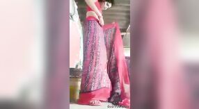 A courageous and stunning rural girl undresses and adorns a saree, showcasing her unshaven underarms and genital area. 2 min 40 sec