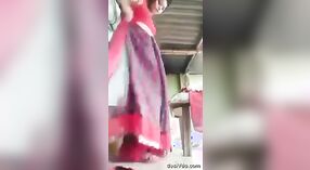 A courageous and stunning rural girl undresses and adorns a saree, showcasing her unshaven underarms and genital area. 3 min 30 sec